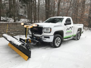 white truck snow plowing