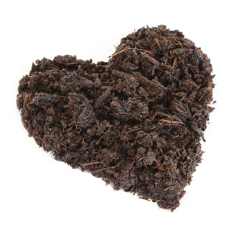 brown mulch pile in shape of heart on white background